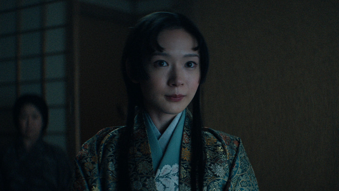 Close up of Usami Fuji with a slight smile inside of Blackthorne's home